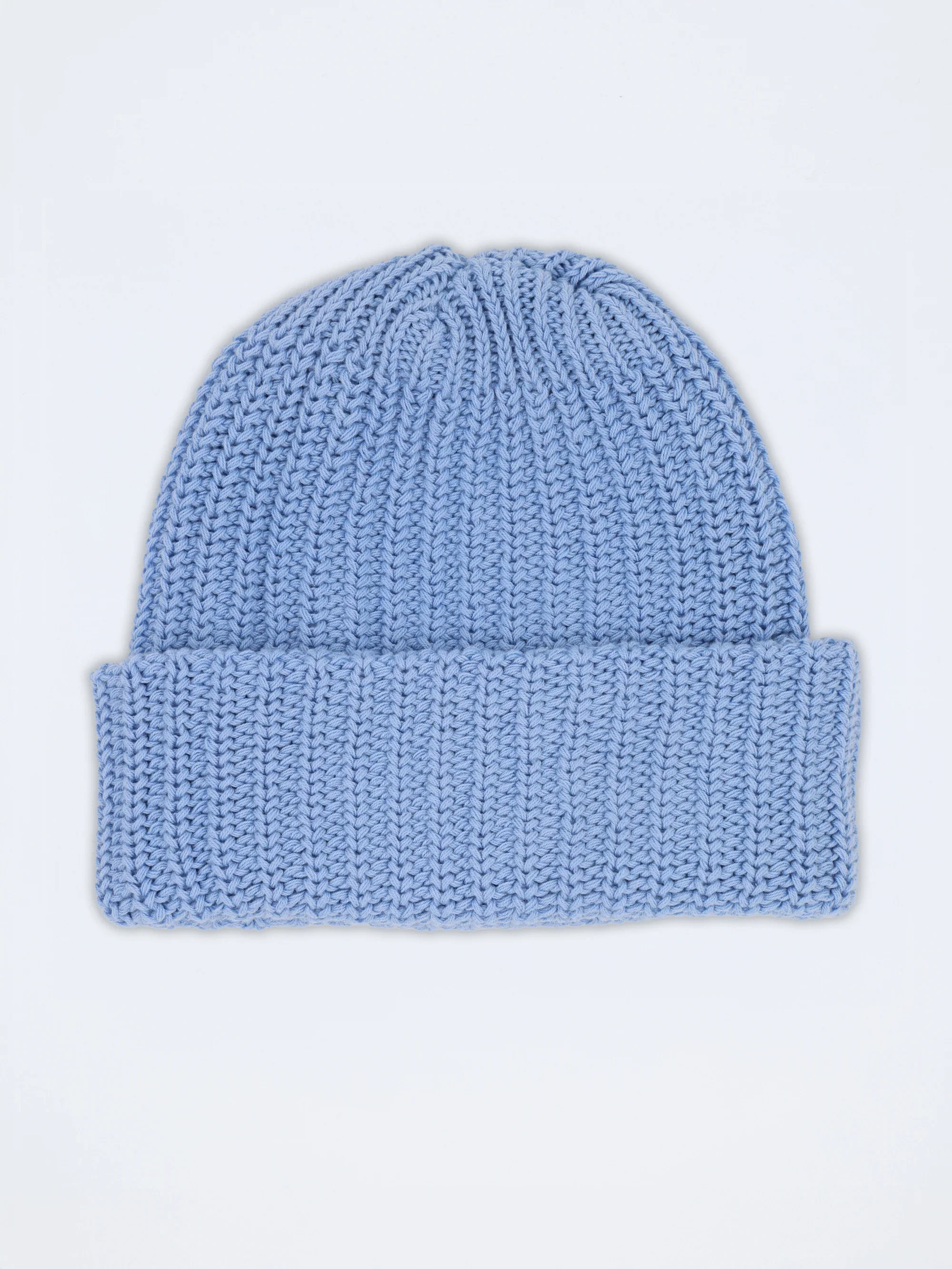 A soft blue Essentials beanie with the cuff rolled and the blue LYM label showing