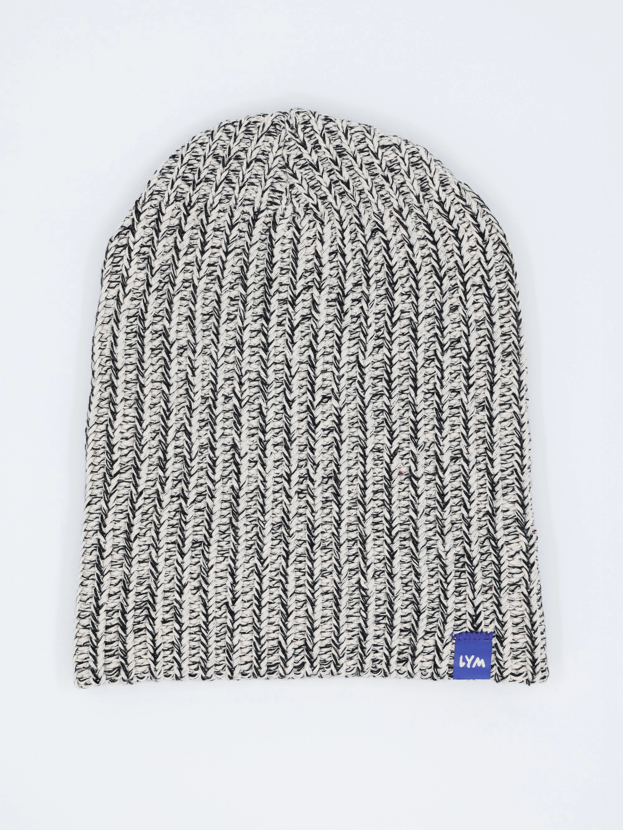 Black and white speckled Essentials beanie, worn long