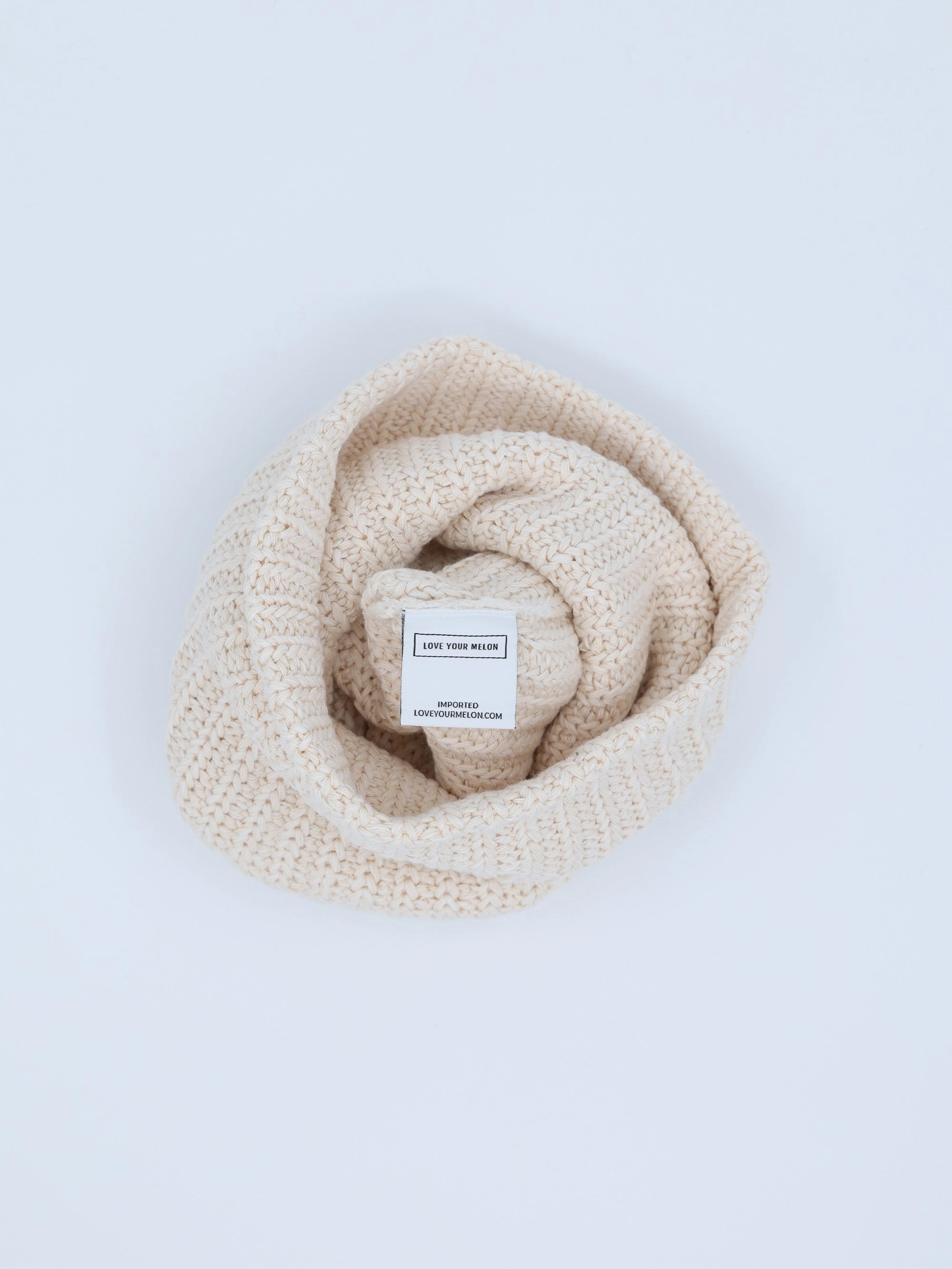 A natural white Essentials beanie rolled up
